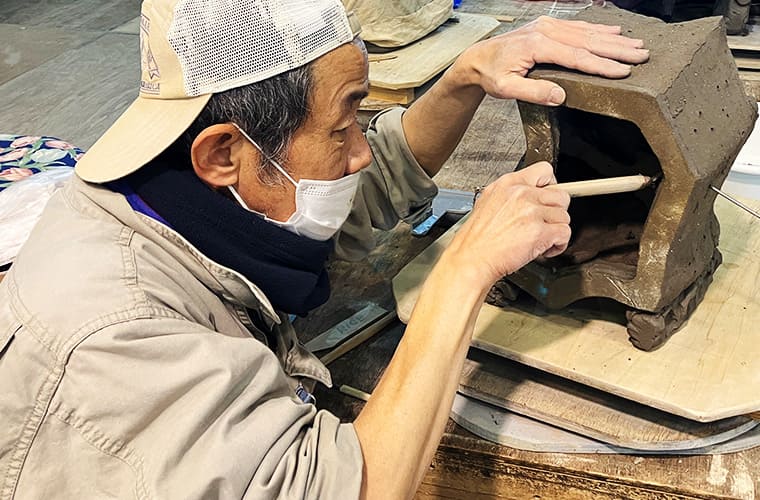 Removing clay from the back of each piece before natural drying