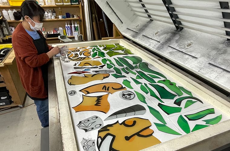 Firing the painted glass in a specialized kiln