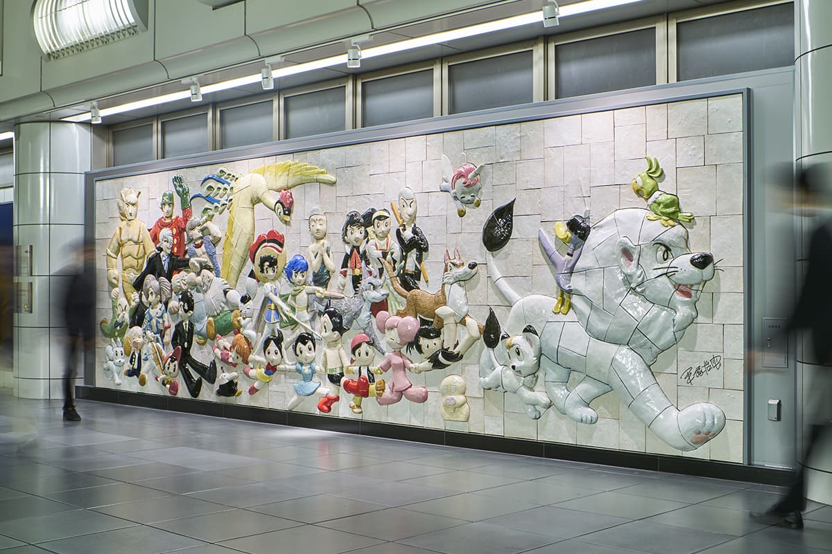 The Ceramic Relief “Osamu Tezuka, Characters on Parade,” installed at Kokusai-tenjijo Station on the Tokyo Waterfront Area Rapid Transit Rinkai Line and created from an Original Painting for anime and manga